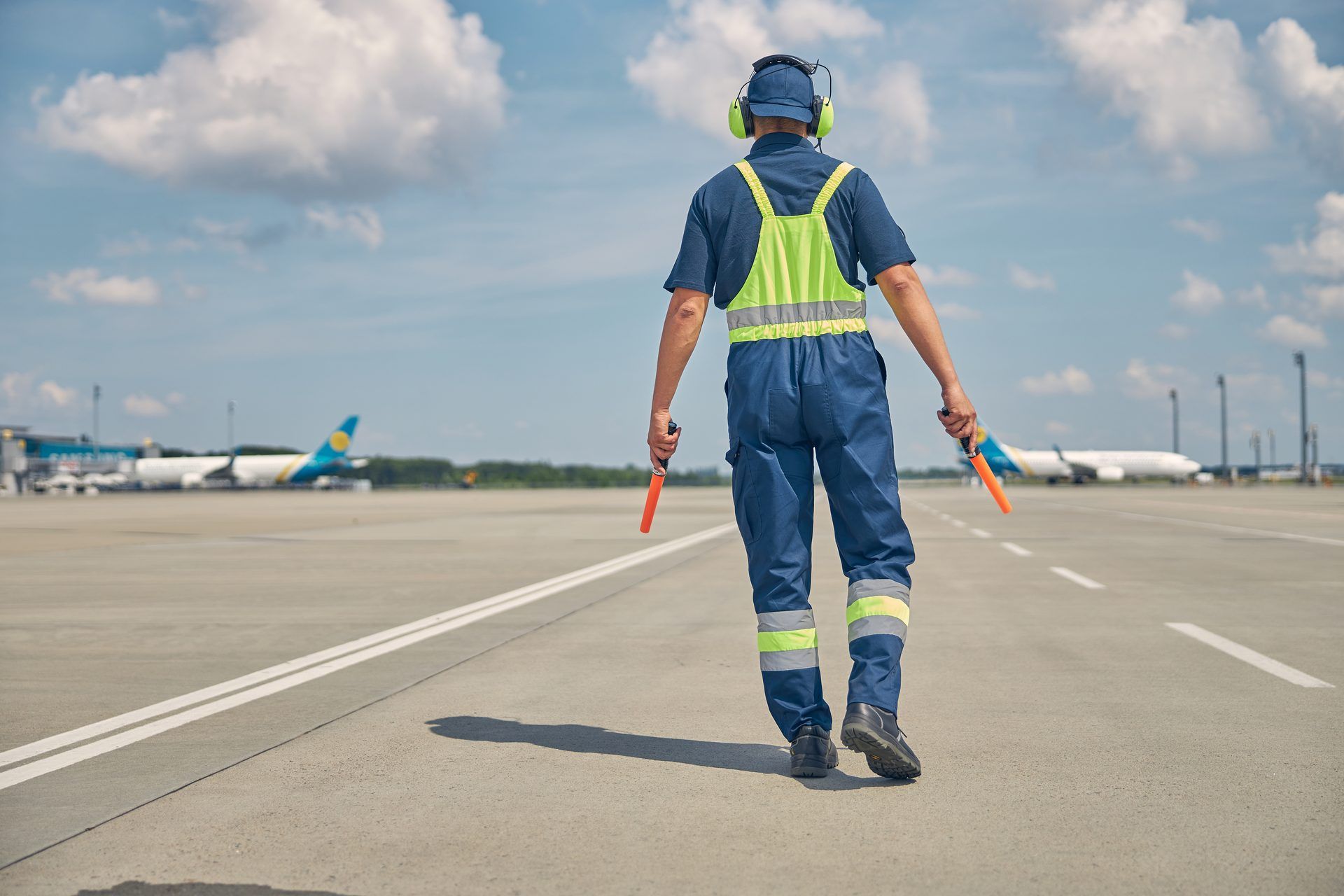 Ground crew member walking the airport apron