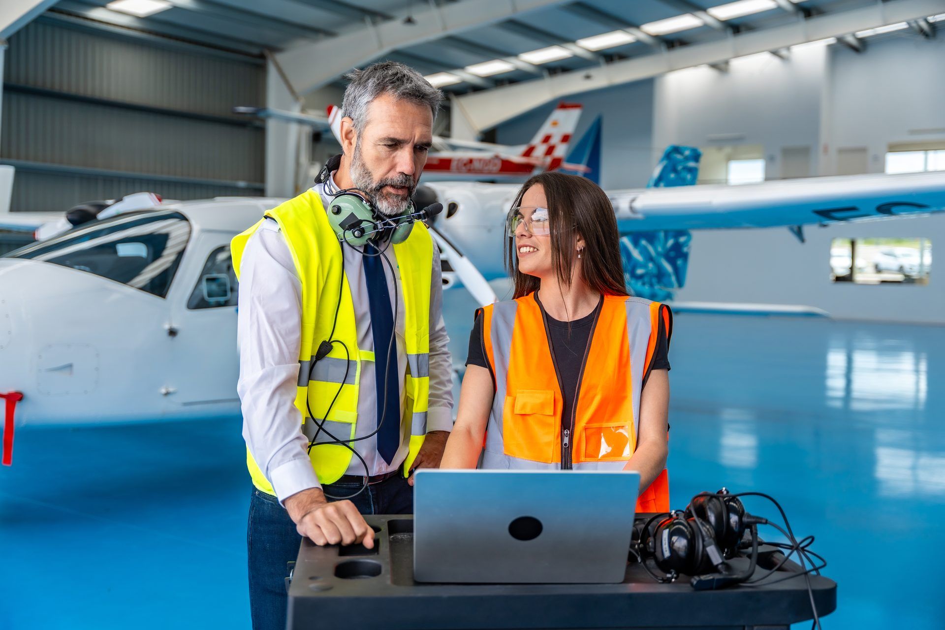 Engineer briefing a colleague in a hangar