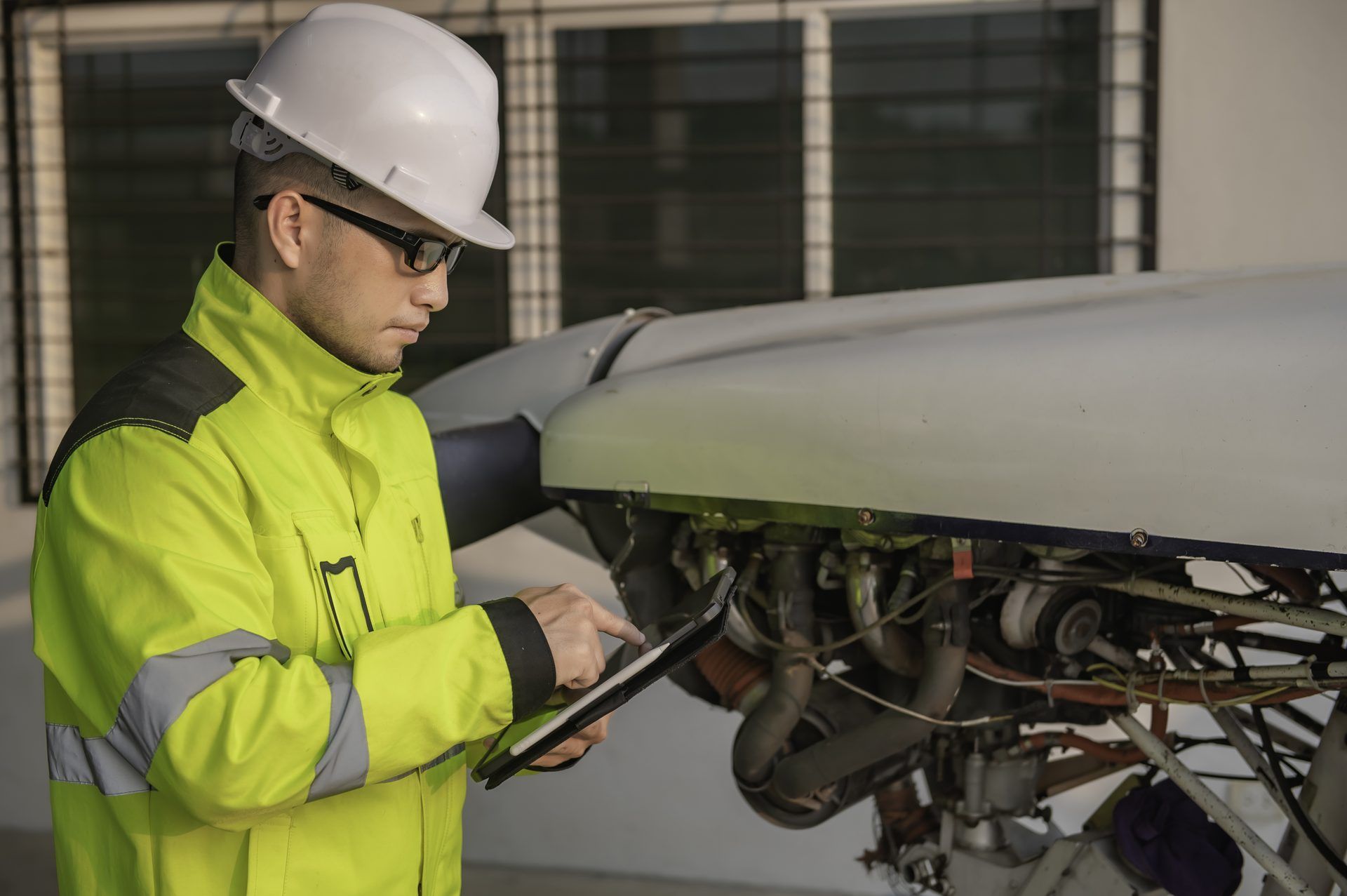 Engineer inspecting an open access panel